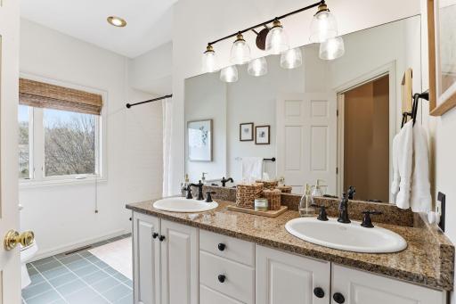 The second full bath on the upper level features elegant finishes and a bright, clean design.