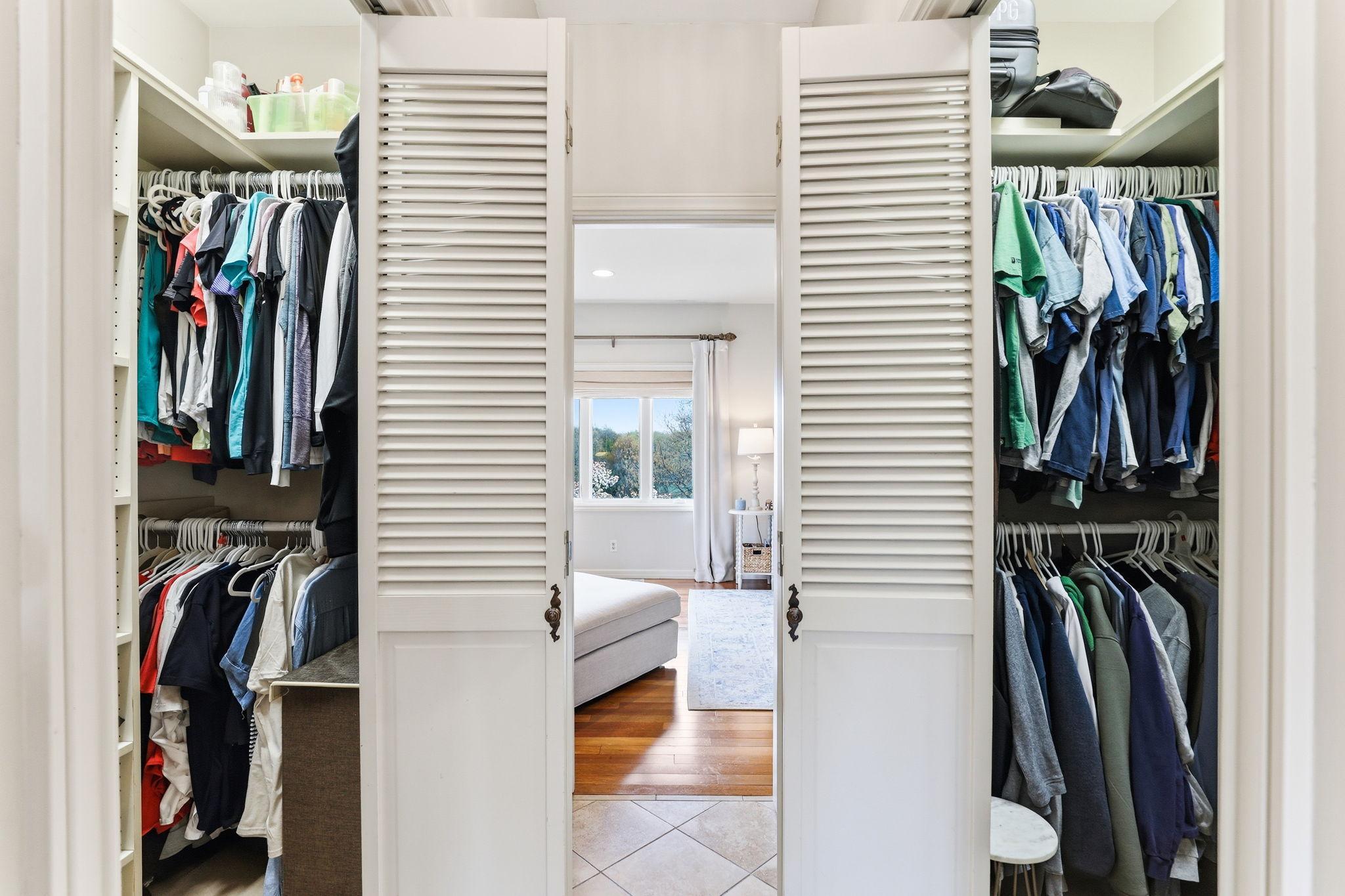 Separate his-and-her closets add convenience and luxury, each offering generous space and built-in shelving for effortless organization.
