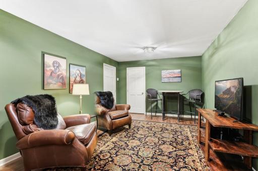 The main-floor bonus room provides a warm and welcoming atmosphere, highlighted by its impressive size and thoughtful layout. Perfect for a cozy family hangout, hobby space, or additional living area, it adapts easily to a variety of needs.