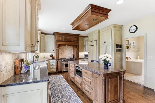 The layout flows seamlessly into a beautifully appointed butlerâs pantry, offering additional storage, serving space, and a refined transition between the kitchen and formal dining areas.