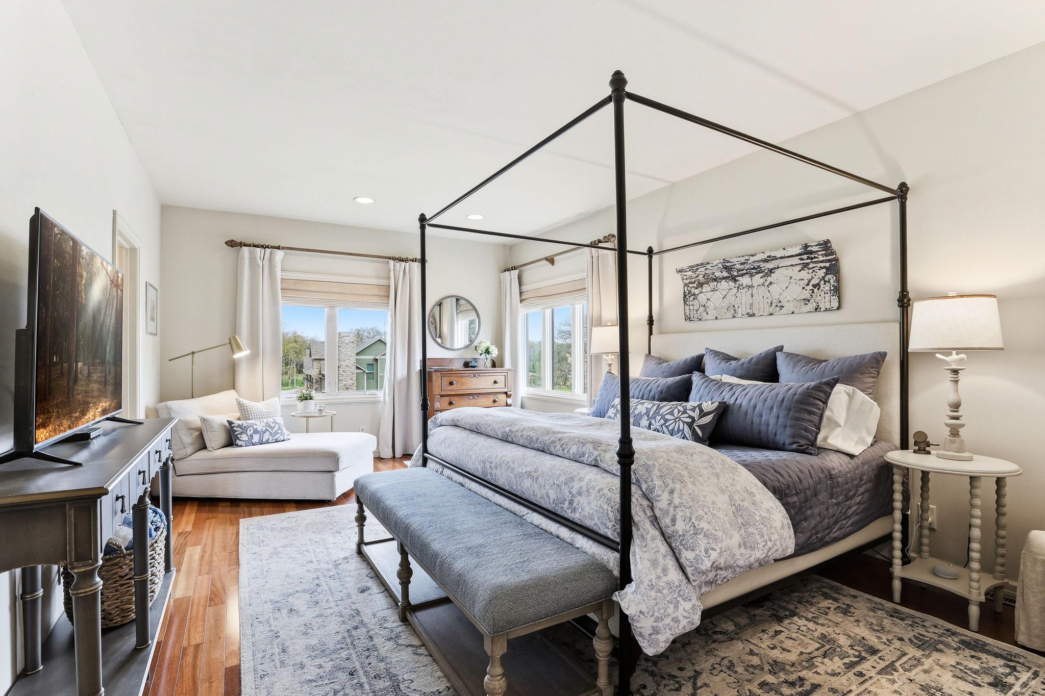 This primary suite blends comfort with luxury, highlighted by beautifully finished hardwood floors and a relaxing atmosphere.