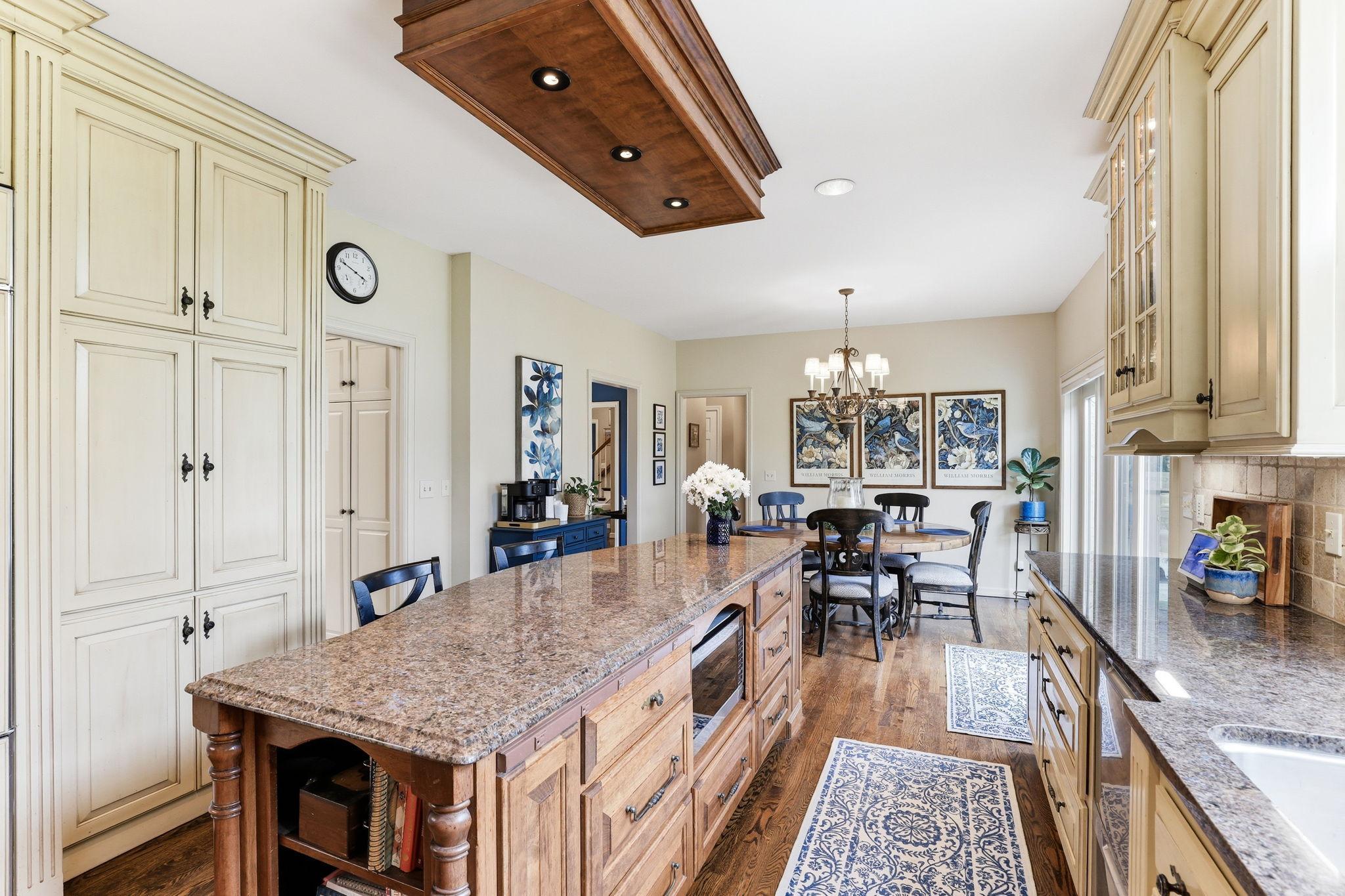 A bold center island serves as the focal point, featuring premium countertops, integrated storage.