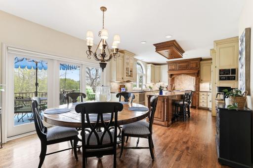 Beautifully designed kitchen blends luxury with comfort, showcasing warm hardwood floors and custom cabinetry.
