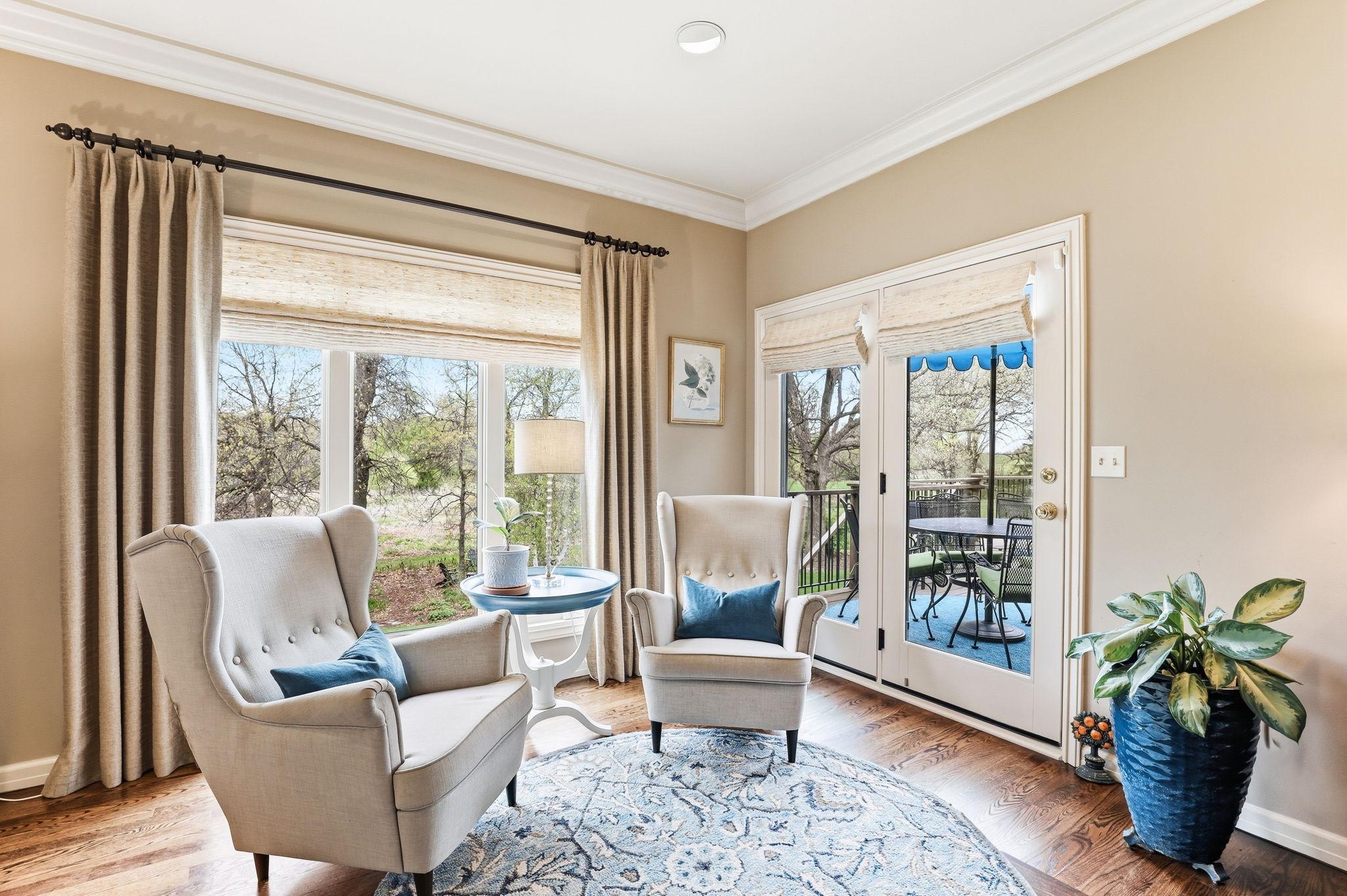 Patio doors lead directly out to the deck, inviting fresh air and natural light into the space.