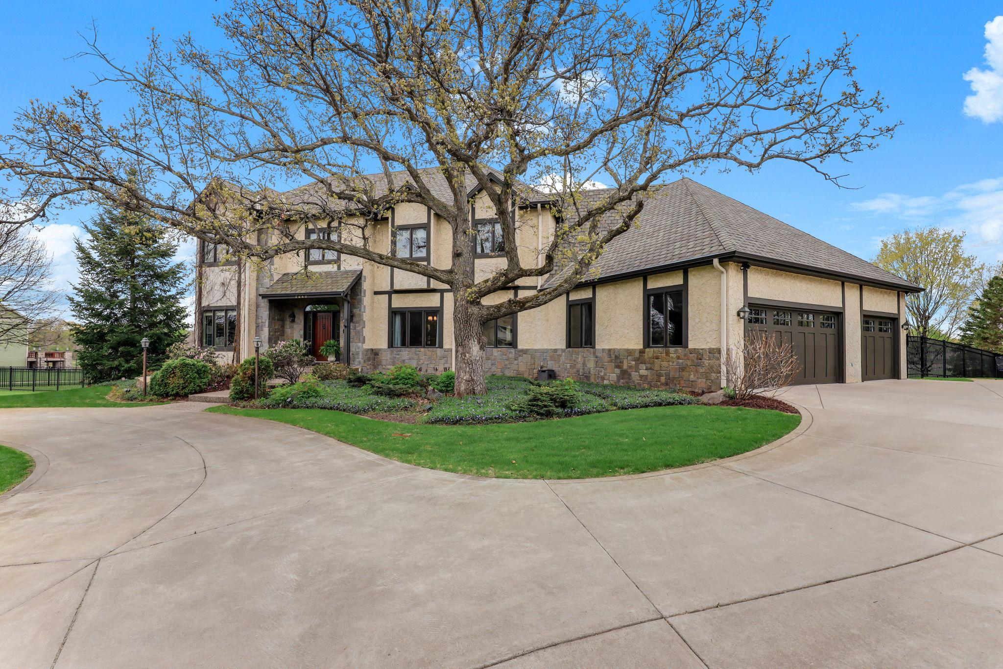 A well-designed three-car garage sits just off the main home, featuring matching exterior finishes.