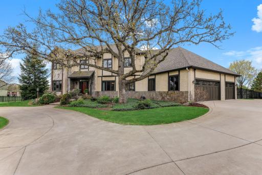 A well-designed three-car garage sits just off the main home, featuring matching exterior finishes.