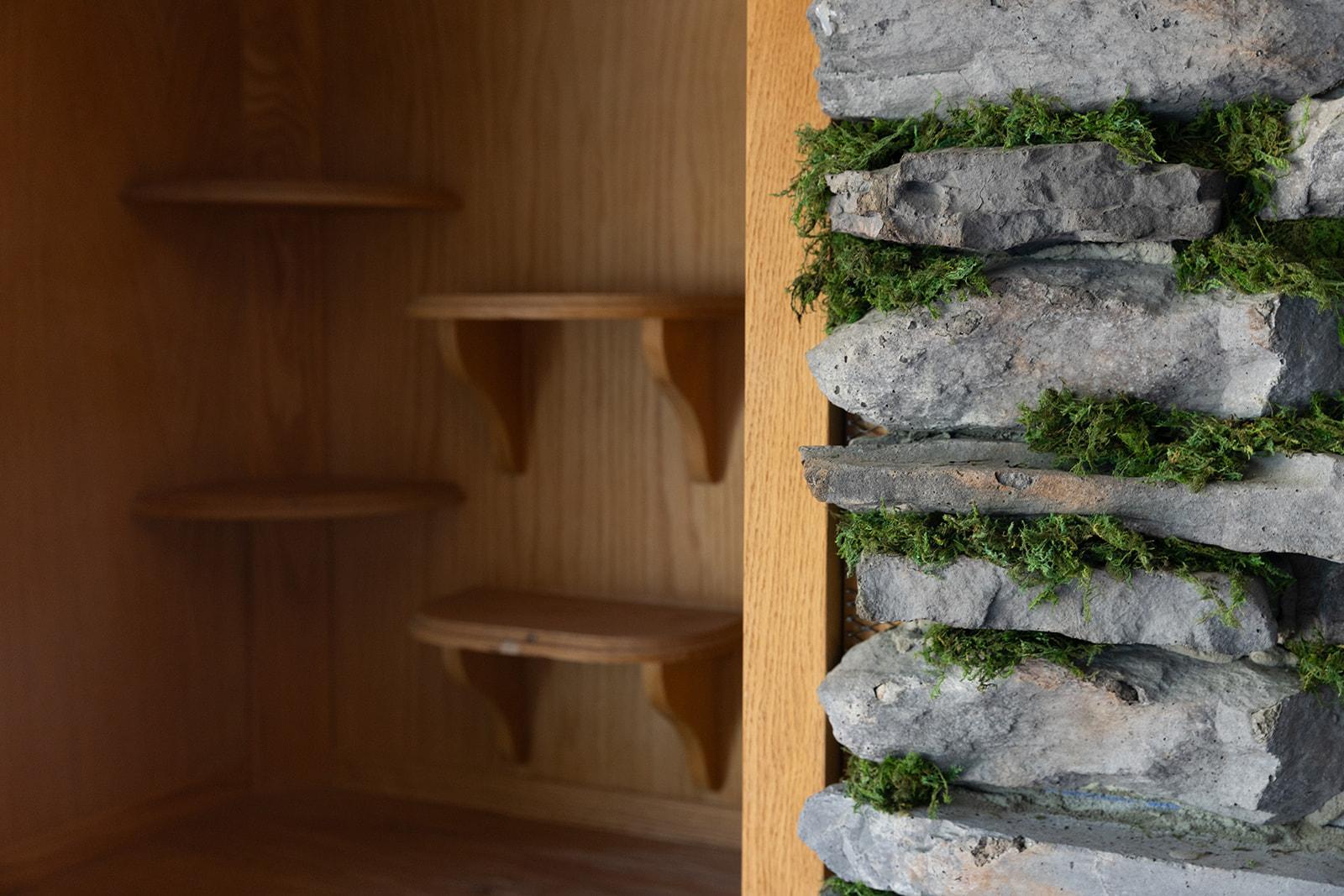 The built in shelves next to the mossy effect of the stones