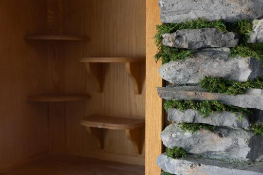 The built in shelves next to the mossy effect of the stones