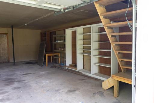 Barn has shelving and stairs to the upper level.