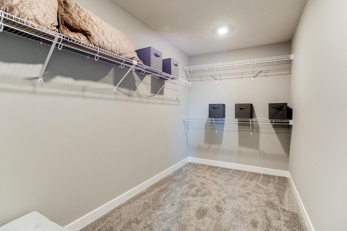 Primary bedroom walk in closet