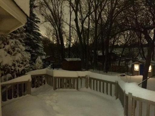 Winter view from the deck into the yard. The light is coming from the shed.