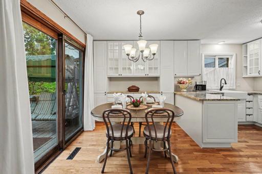 The dining area features a built in buffet and lighted glass cabinets. The sliding patio door leads to the deck and yard.