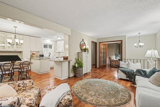 The open floorplan flows between living room, dining and kitchen area.