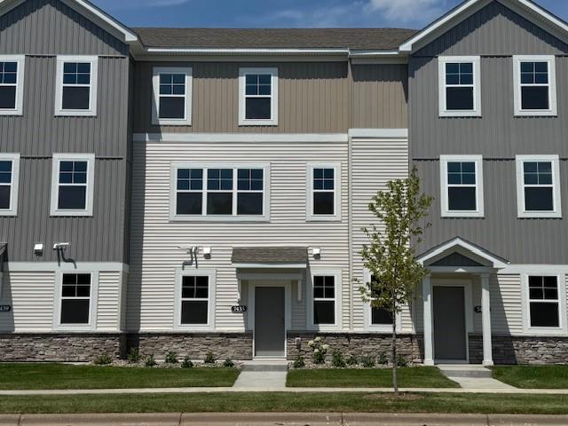 Modern design highlighted by stone accents & clean architectural lines. A charming front patio offers the perfect spot to relax, while the expansive windows fill the home with natural light. Similar home shown, color can vary.
