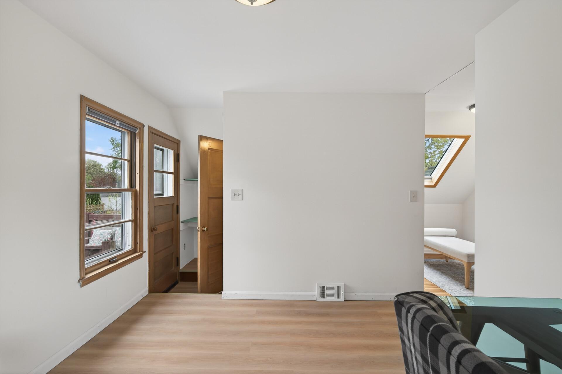 At the top of the stairs is a deck above the sunroom and a wonderful flex space for an office or sitting room.