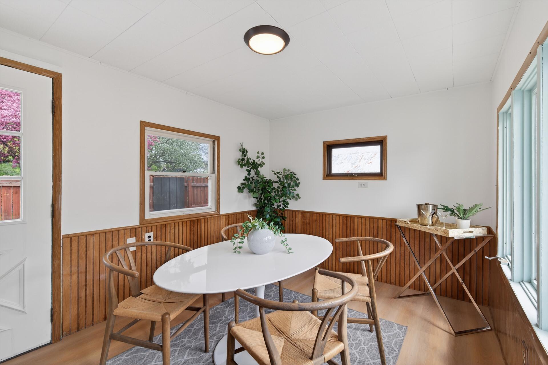 The sun room can be used as a dining room or a lounge space