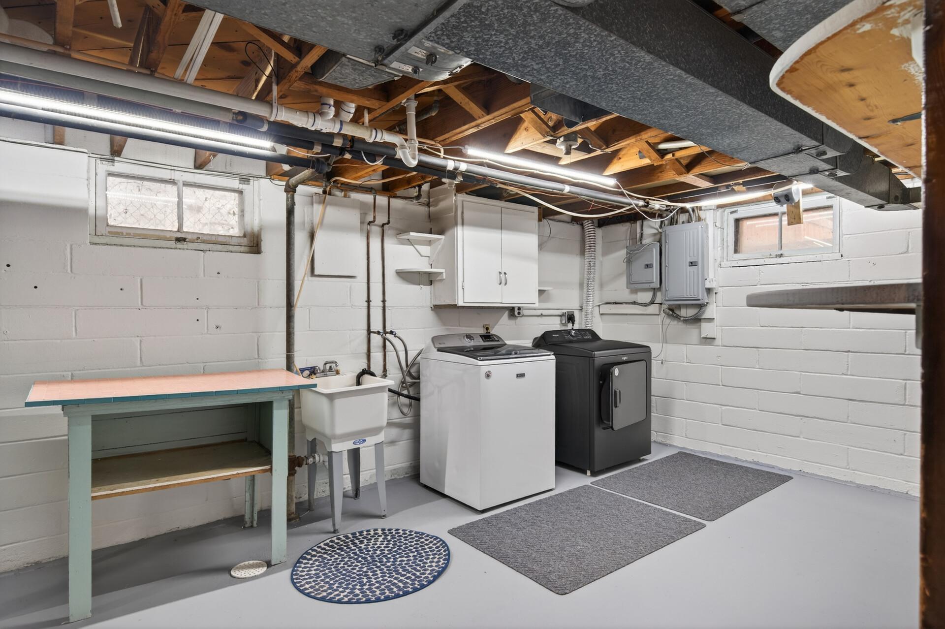 Spacious utility room has tons of room for laundry and storage.