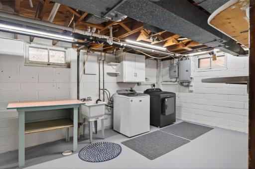 Spacious utility room has tons of room for laundry and storage.