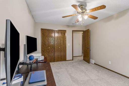 Another view of the office with ceiling fan and overhead light.