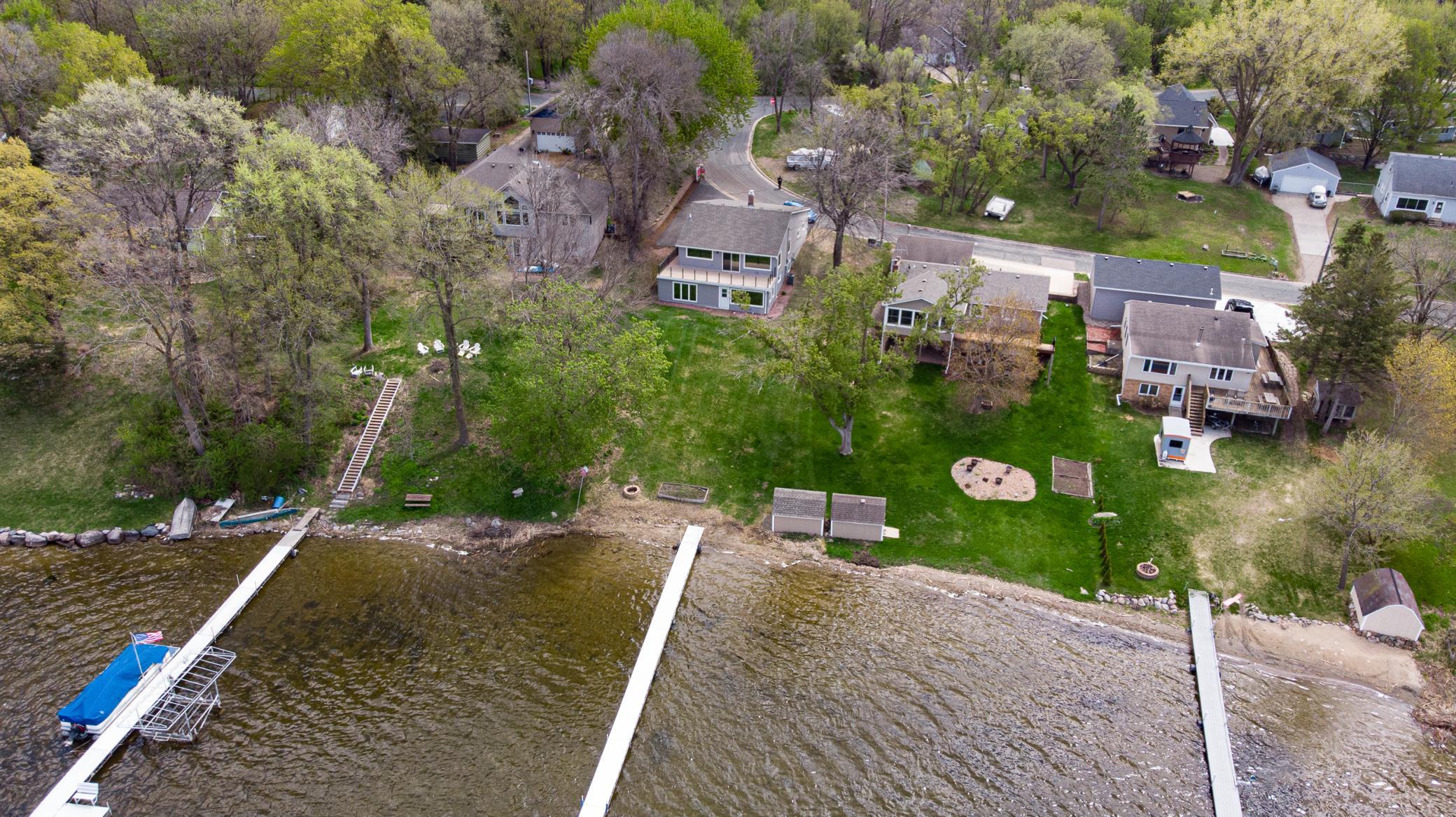 PANORAMIC WATERSCAPES will be your daily view at this inviting TURNKEY WALKOUT RAMBLER offering 60 feet of West-facing shoreline with expansive views of Spring Lake! Enjoy lake views from the NEW Timber Tech composite deck with glass railings!