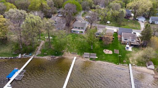 PANORAMIC WATERSCAPES will be your daily view at this inviting TURNKEY WALKOUT RAMBLER offering 60 feet of West-facing shoreline with expansive views of Spring Lake! Enjoy lake views from the NEW Timber Tech composite deck with glass railings!