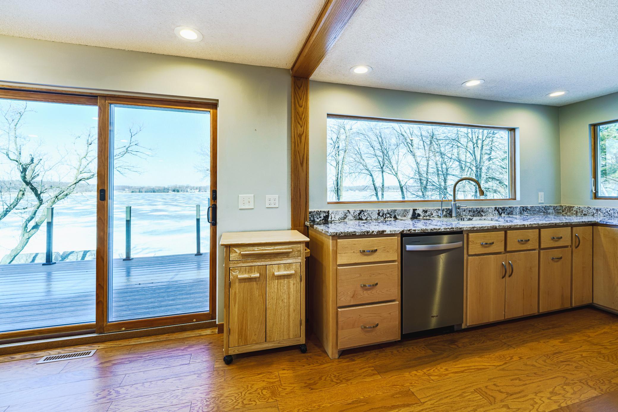The kitchen was recently remodeled, and includes new cabinetry by Metro Cabinets, granite countertops, and stainless appliances including a new dishwasher.