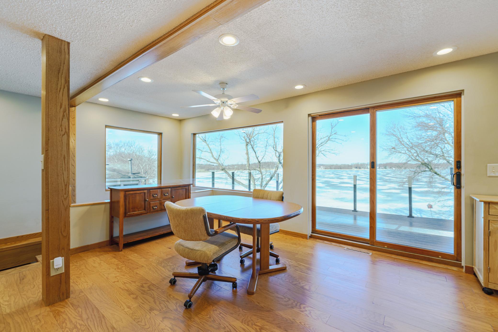 The dining space is incredibly light and bright, and leads to the deck. The addition of the larger windows improves the style and livability of this level.