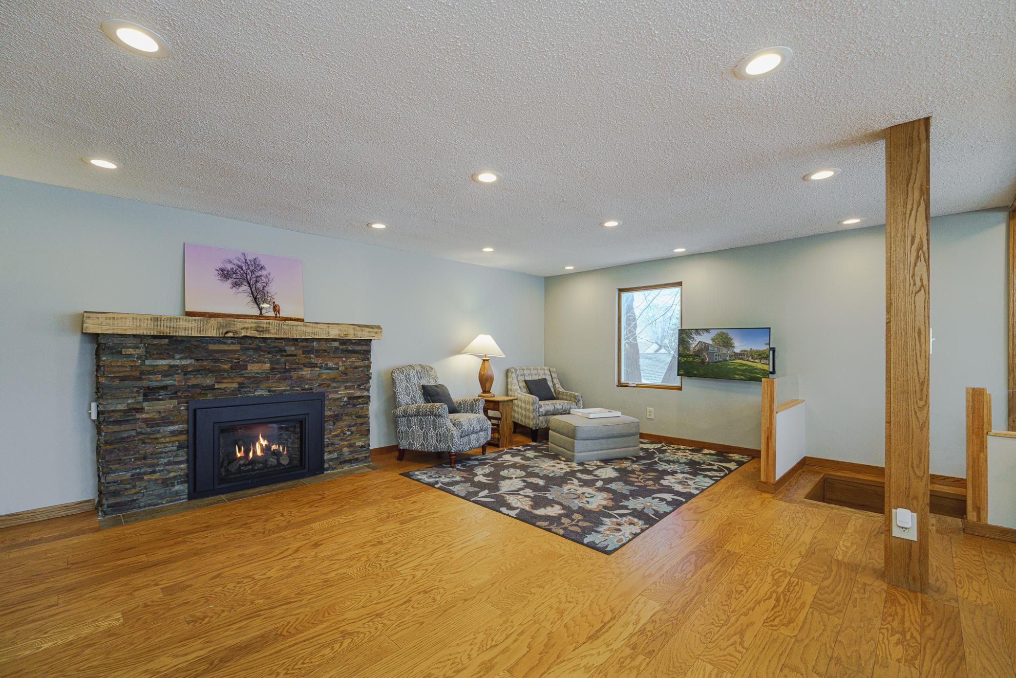 The main floor family room features BRAND NEW WINDOWS, hardwood floors and a gas fireplace with dry-stack stone surround, all added by the current homeowner.