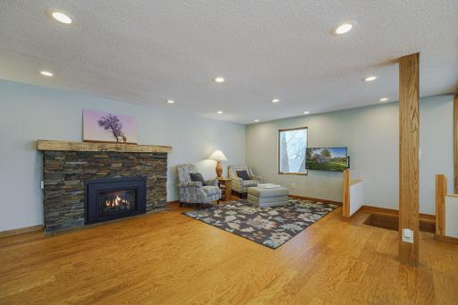 The main floor family room features BRAND NEW WINDOWS, hardwood floors and a gas fireplace with dry-stack stone surround, all added by the current homeowner.