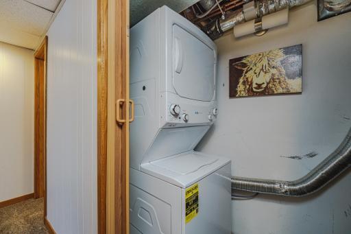 The laundry area is conveniently located off the lower hall, where it can be easily accessed by both bedrooms and the porch/lake spaces. There is a large hall closet opposite the laundry area.