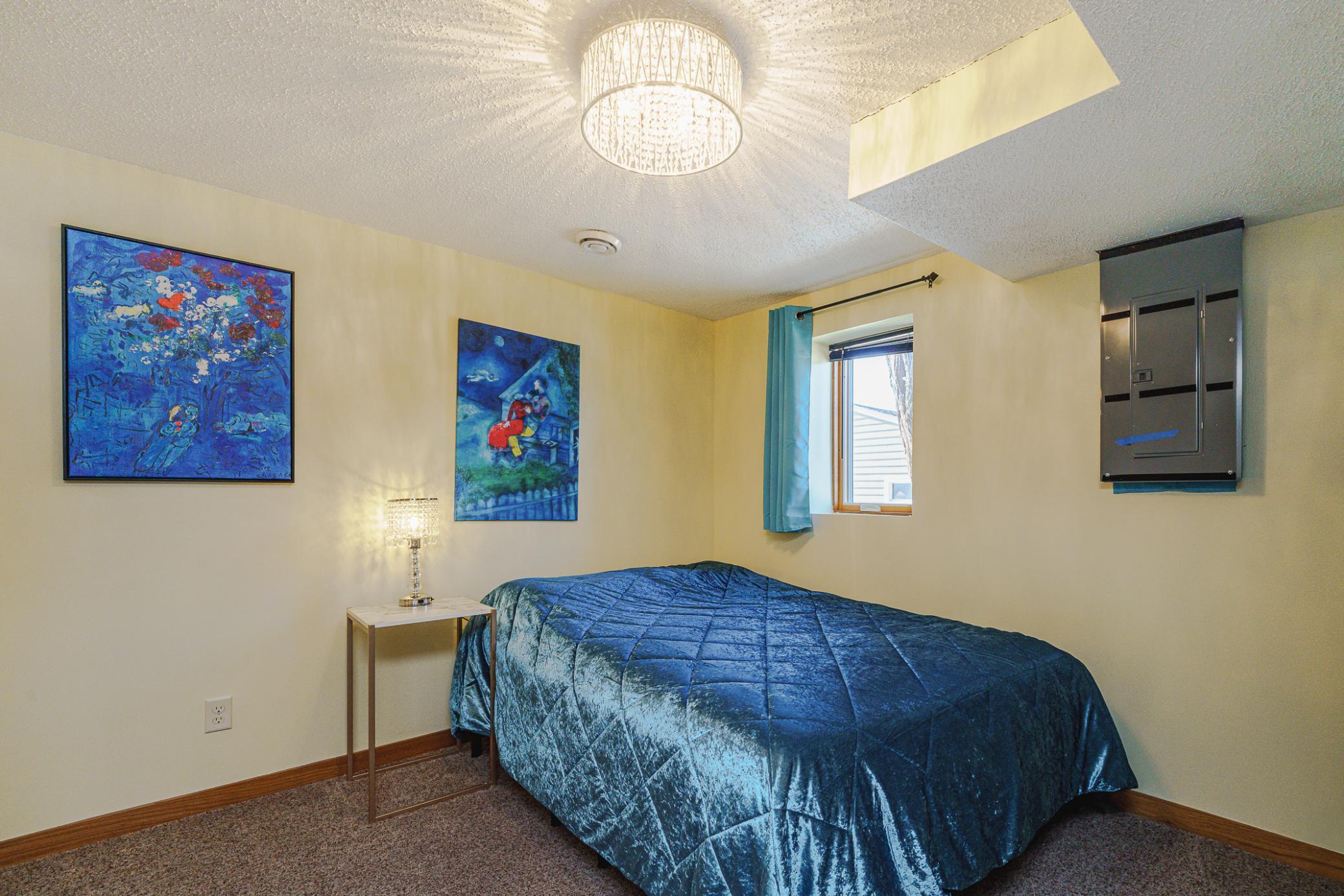 This is the first bedroom on the lower level. It has a refreshed light fixture.