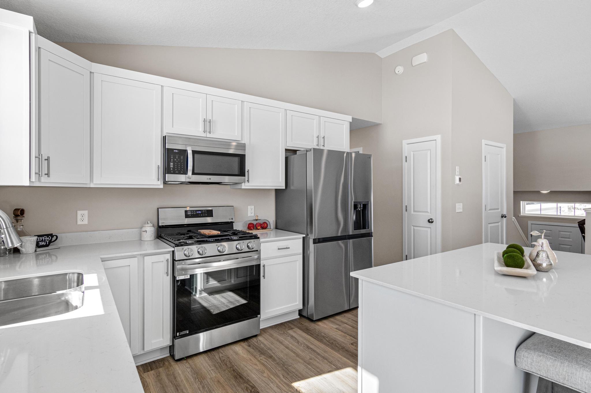 Photo taken of another home with similar plan and finishes. Photos and renderings may not depict actual plan, materials, & finishes may vary. All measurements are approximate.