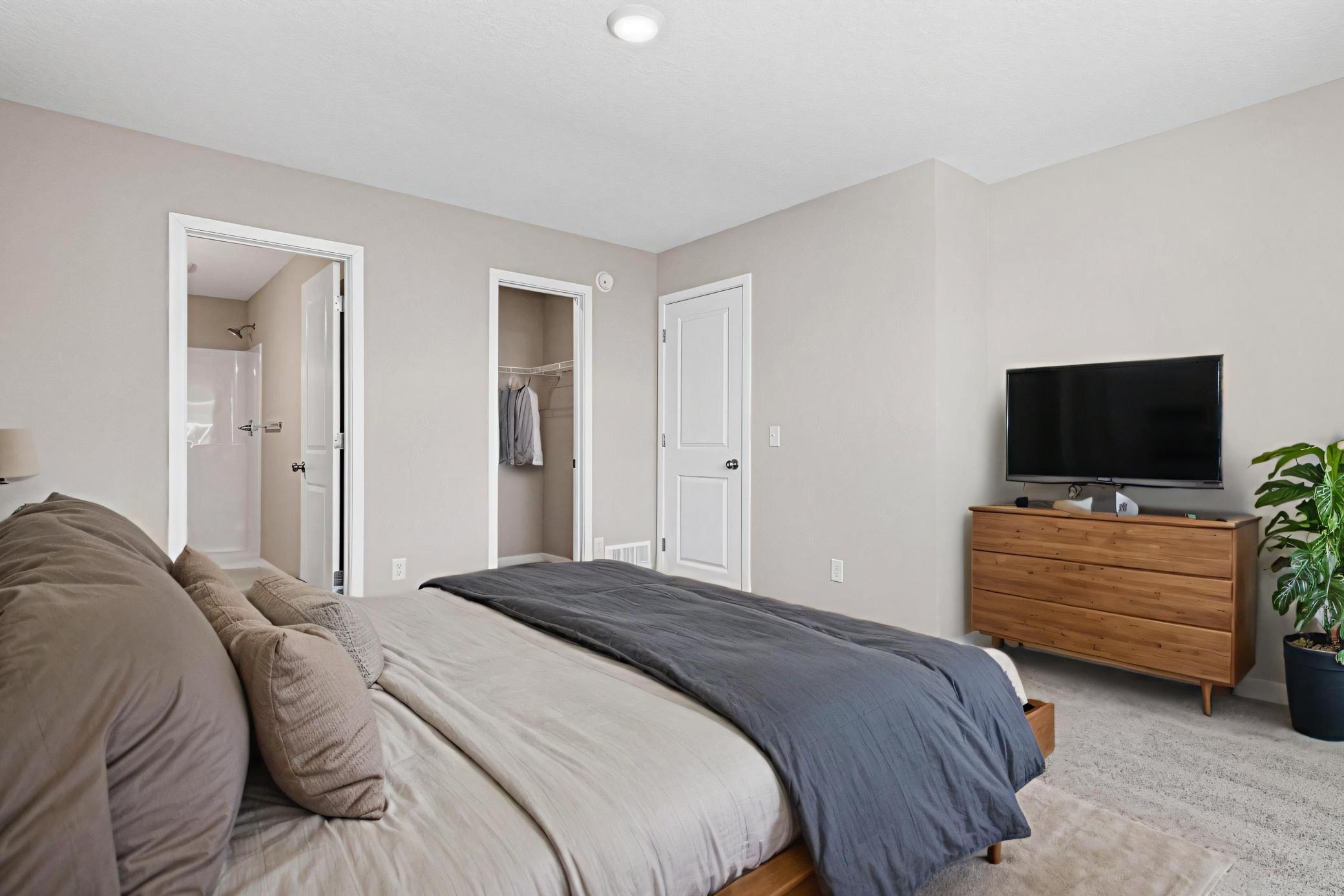 Primary Suite, Virtually Staged. Photo taken of another home with similar plan and finishes. Photos and renderings may not depict actual plan, materials, & finishes may vary. All measurements are approximate.