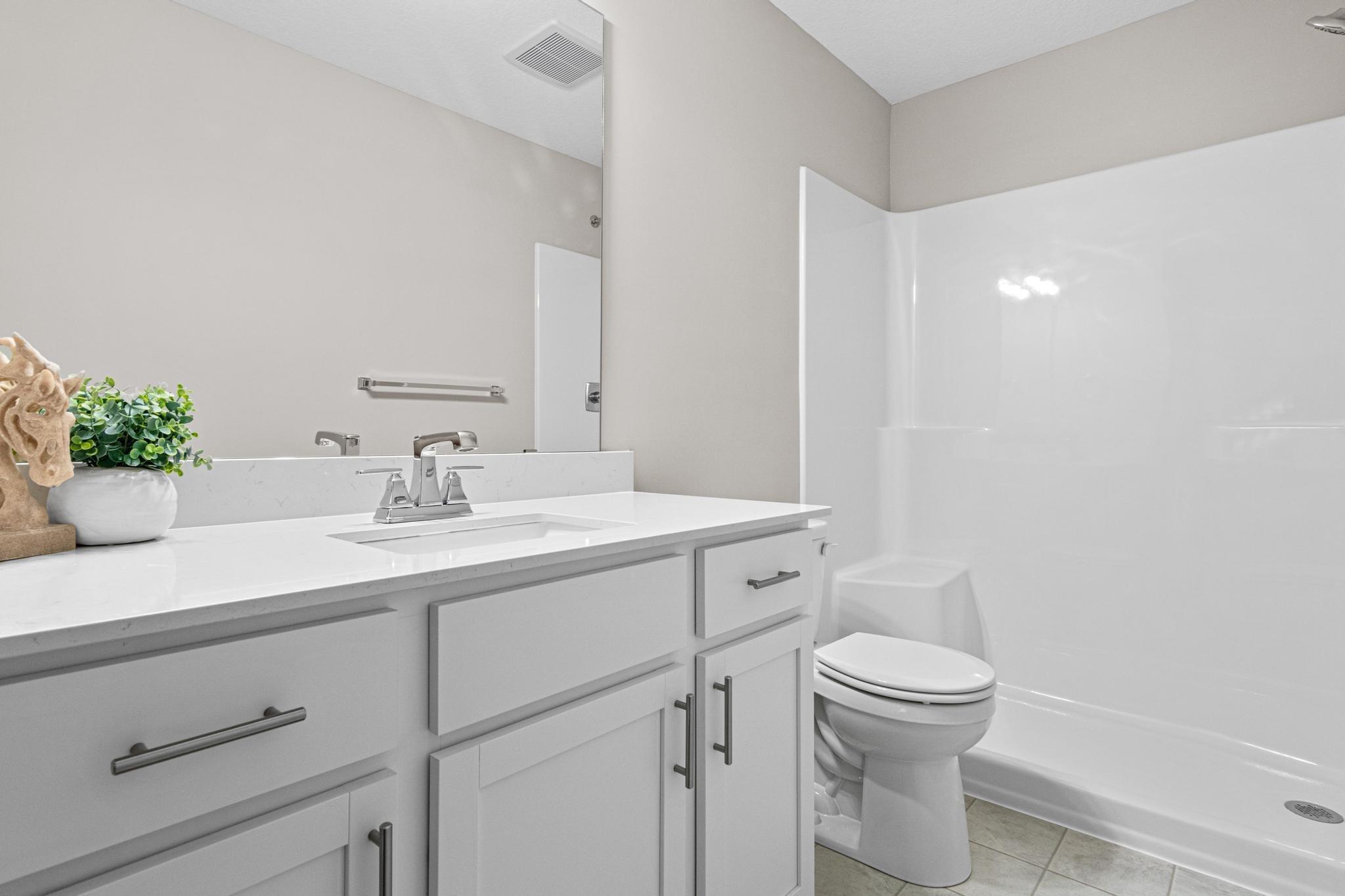 Primary Bathroom. Photo taken of another home with similar plan and finishes. Photos and renderings may not depict actual plan, materials, & finishes may vary. All measurements are approximate.
