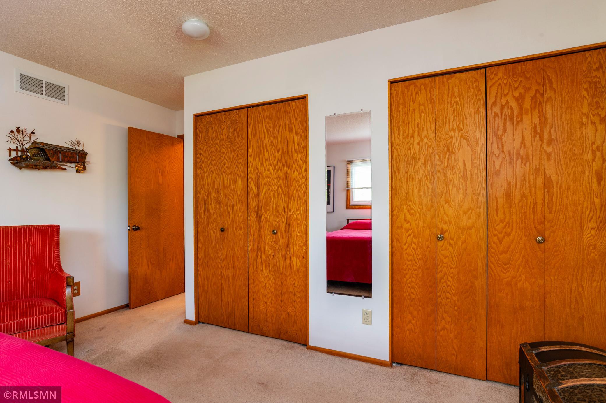 Primary bedroom double wardrobe closets.