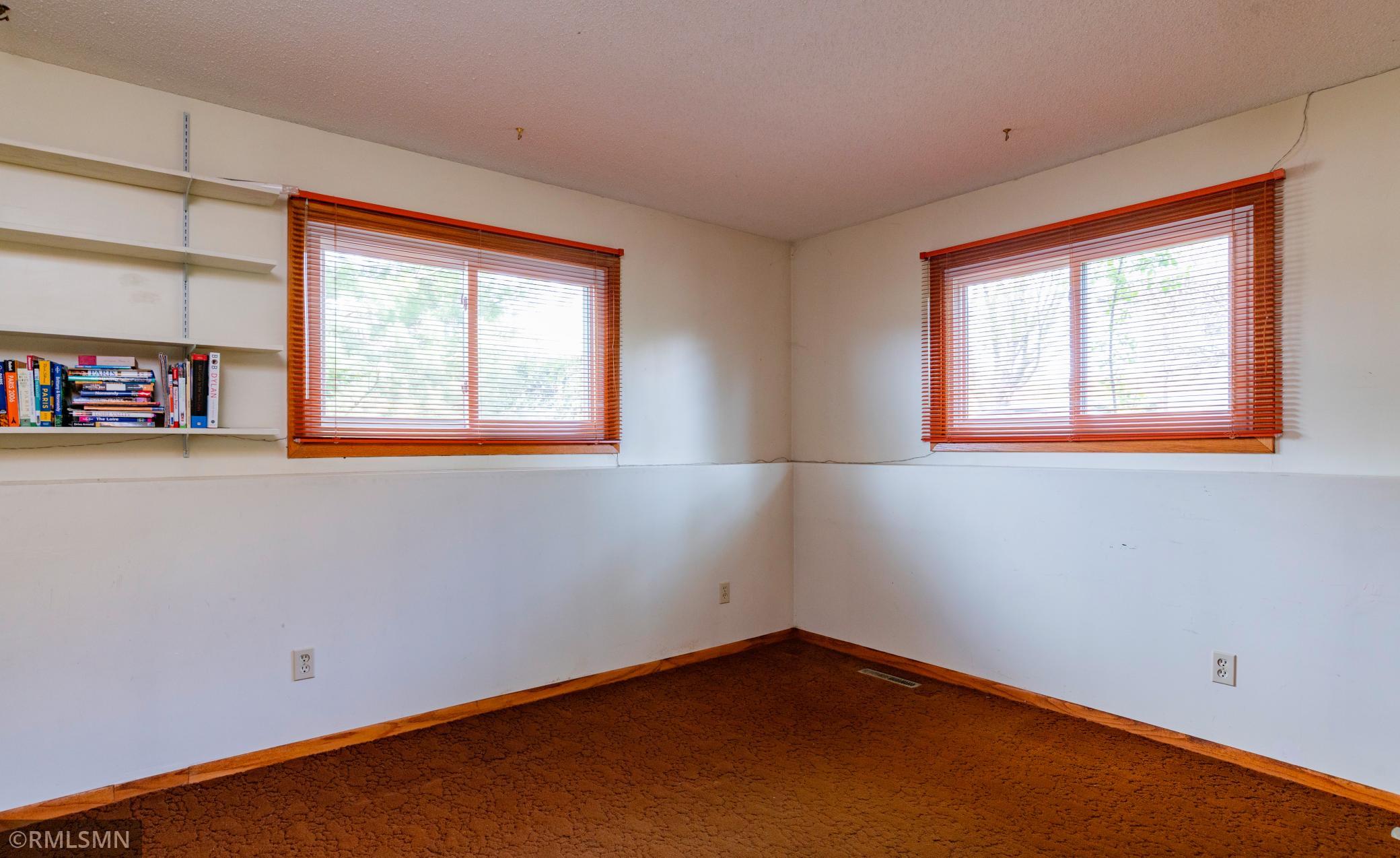 Versatile lower level third bedroom is well-suited to serve as a study or home office.