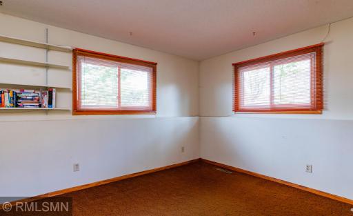 Versatile lower level third bedroom is well-suited to serve as a study or home office.