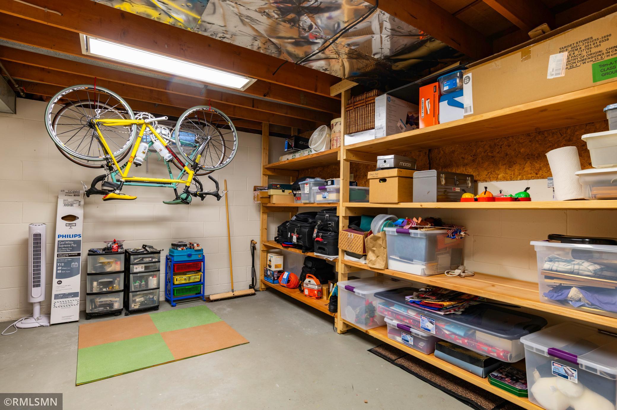 Shelves galore in the large basement utility/laundry/storage room.