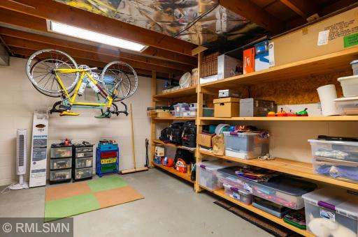 Shelves galore in the large basement utility/laundry/storage room.