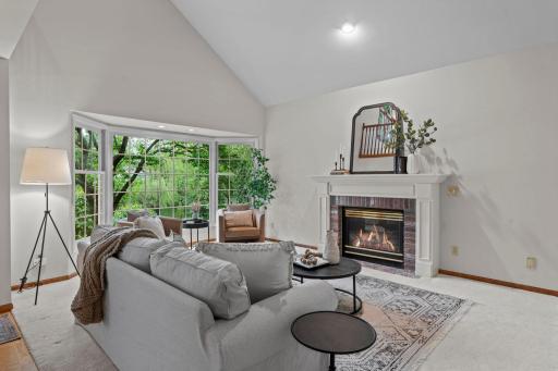 Formal living room with large bay window and gas fireplace