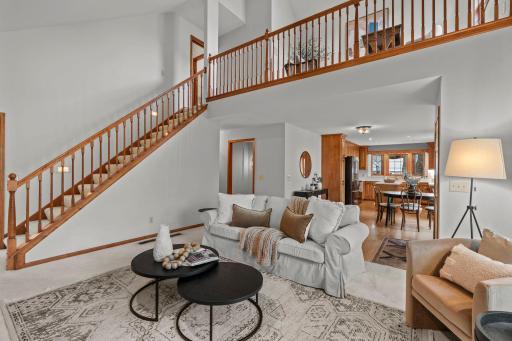 Open vaulted living room and stairway to upper level