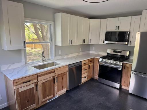New cabinetry, quartz counters, stainless appliances, and updated fixtures