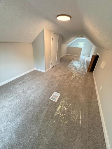 Spacious upper level bedroom with charming 1.5-story character