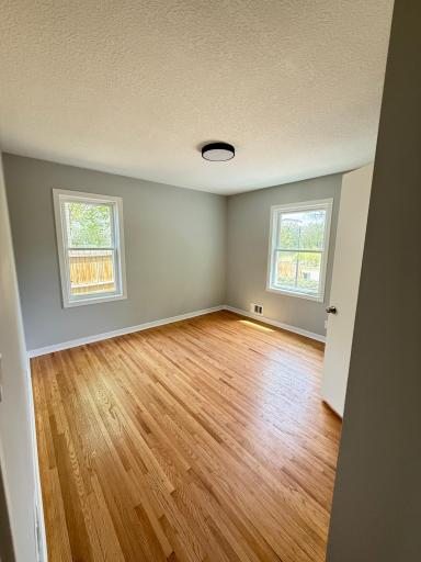 Main level primary bedroom with original hardwood floors