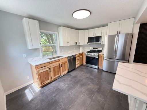 Bright renovated kitchen with new appliances and modern finishes