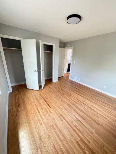 Primary bedroom with closet storage and fresh paint