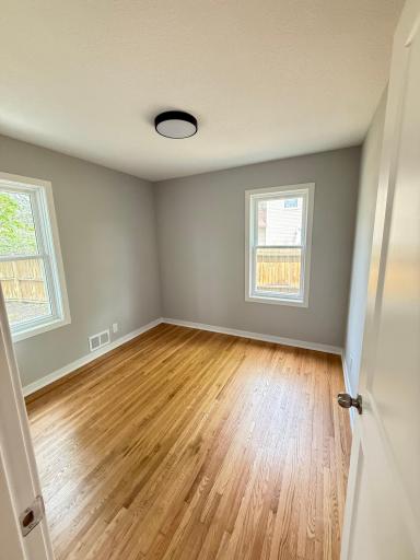 Main level second bedroom with refinished hardwood floors