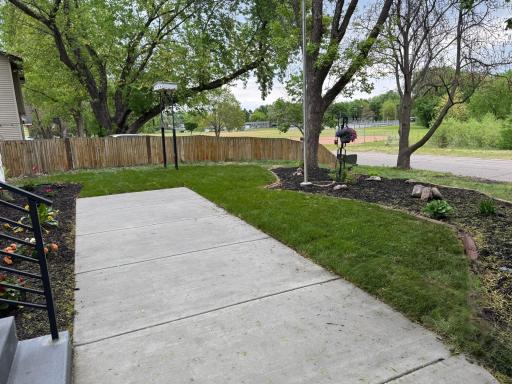 Spacious yard with mature shade trees and fresh patio space