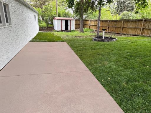 New patio overlooking backyard and detached garage