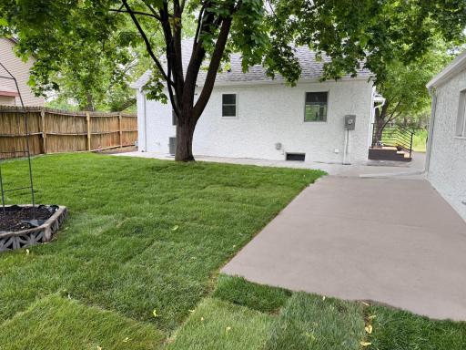 Backyard view with new concrete patio and green space